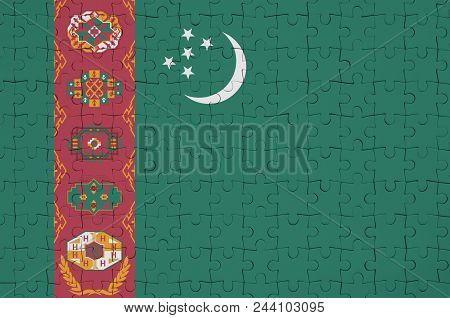 Turkmenistan Flag  Is Depicted On A Folded Puzzle