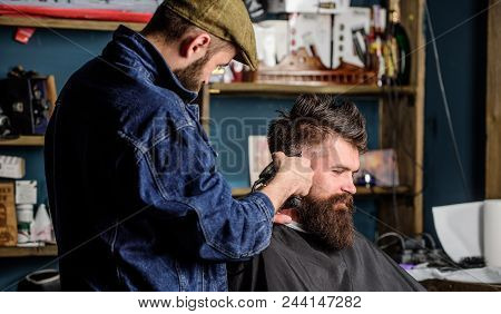 Hipster Lifestyle Concept. Hipster Client Getting Haircut. Barber With Hair Clipper Works On Hairsty