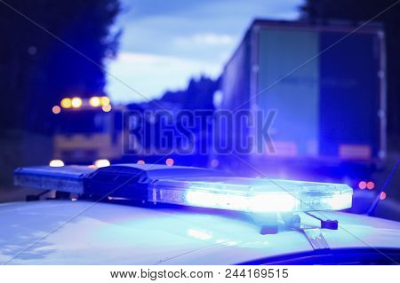 Police At Night In The Car With Blue Siren Flasher. Siren On Police Car Flashing, Close-up.