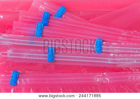 Closeup pink plastic zip lock bag with blue sealing to pack store cloths and resealable