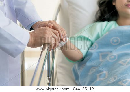 Friendly Man Doctor Hands Holding Patient Hand Sitting At The Desk For Encouragement, Empathy, Cheer