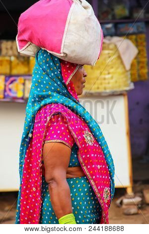 Agra, India - November 10: Unidentified Woman Carries Bag On Her Head At Kinari Bazaar On November 1