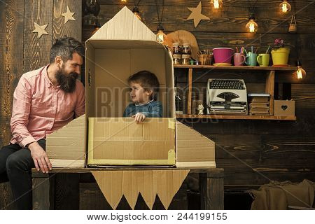 Dreams Of Space. Kid Happy Sit In Cardboard Hand Made Rocket. Boy Play With Dad, Father, Little Cosm