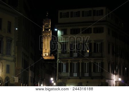 Florence, Italy - October 30 2015: Night View Of Historic Arnolfo Tower In Florence, Through Buildin