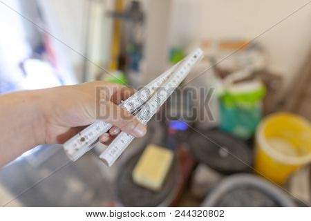 Hand Holds A German Double Meter Stick On A Construction Site