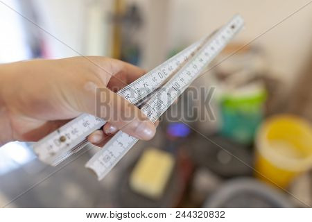 Hand Holds A German Double Meter Stick On A Construction Site