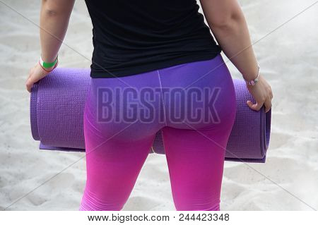Fit Woman At The Gym Holding A Yoga Mat