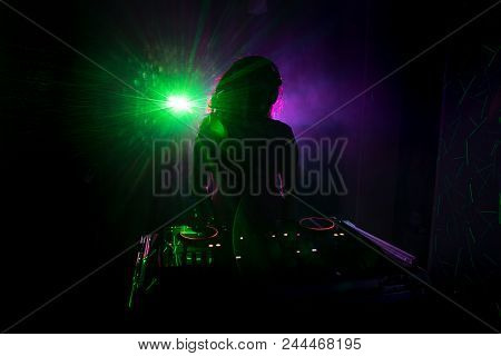 Dj Spinning, Mixing, And Scratching In A Night Club, Hands Of Dj Tweak Various Track Controls On Dj'