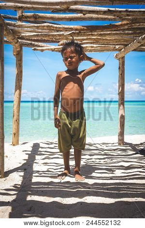 Bintang Biru Island, Sabah Malaysia : May  1st, 2016 - Portrait Shot Of A Shirtless Boy Underneath A