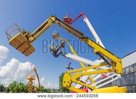 Fragment Of The Booms With Baskets And Top Parts Of Different Articulated Boom Lifts And Scissor Lif