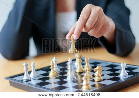 Close Up Shot Hand Of Business Woman Moving Golden Chess To Defeat A Silver King Chess On White And 