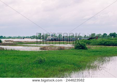 Barge Floating On The River, Flooded Trees And Meadows, The Nature Of Belarus, The Flood Season