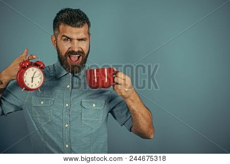 Morning Begins With Coffee. Hipster With Milk Cup, Time. Happy Guy With Mulled Wine, Clock On Blue B