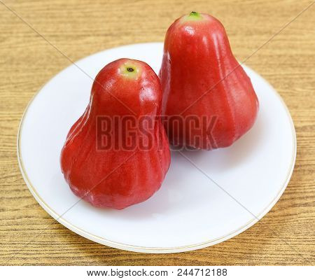 Fresh Red Ripe Water Apples, Rose Apples, Water Guava Or Jambu Air On A White Plate.
