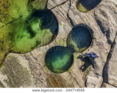 Relaxing Poolside, Coastal Rock Pools Glistening In Vibrant Jewl-like Colours On The Coastal Rock Sh