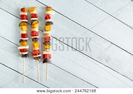 Table Top Shpt Of Cold Colorful Mixed Fruit Salad Served On Barbecue Sticks As A Summertime Dessert