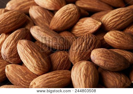 grain scattered handful of almonds close up