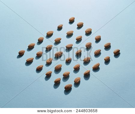 Figured pattern of almonds on a blue background