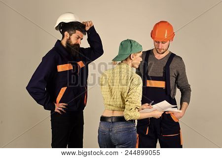 Woman Superior. Brigade Of Workers, Builders In Helmets, Repairers And Lady Discussing Contract, Gre