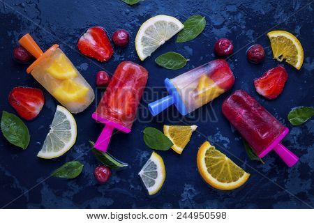 Homemade Bright Fruit Popsicle With Strawberry, Cherry, Lemon, Orange, Lemon And Mint Flavor And Fre