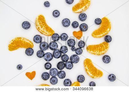 Fresh Blueberry  With Mandarin Slices On White Background. A Composition Of The Blueberries And Mand
