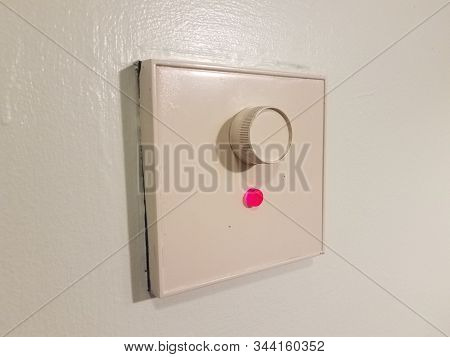 White Dimmer On Wall With Red Light