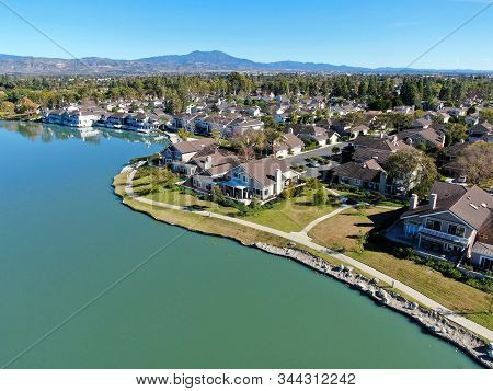 Aerial View Of North Lake Surrounded By Residential Neighborhood During Blue Sky Day In Irvine, Oran