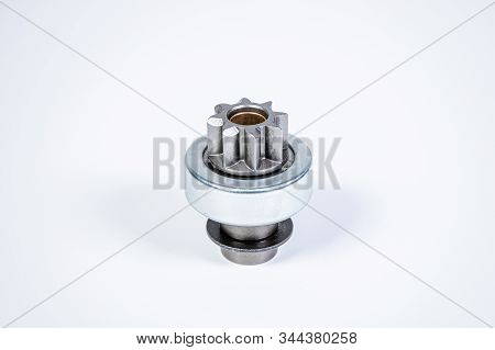 New Spare Parts - Starter Gear Drive For Motor Starter On A Gray Background. Classic Gear Transmissi