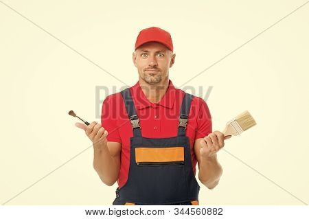 Which One. Decorator Creative Work. Paint And Renovate. Decorator Painting Wall. Man Hold Brushes Wh