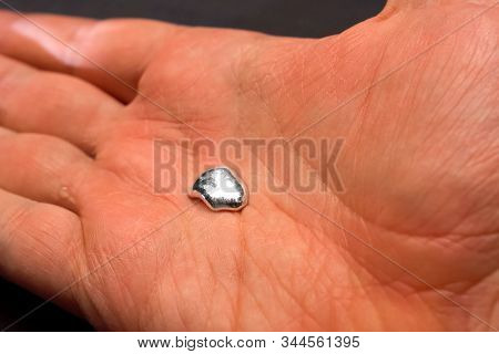 Liquid Metal In The Hands Of A Man. Fusible Metal