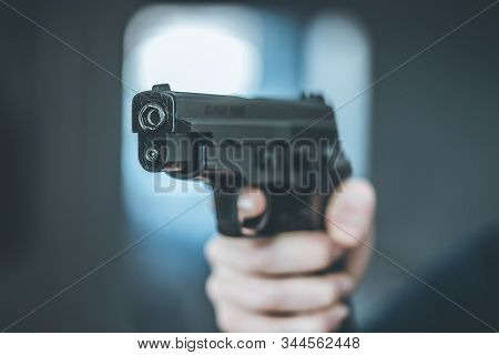 Man Is Holding A Black Fire Weapon, Closeup