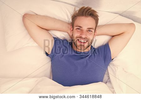 New Smile, New Day. Happy Man Awaken In Bed. Handsome Caucasian Man With Happy Smile Relaxing In The