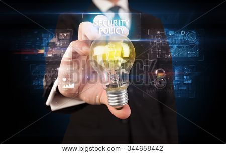 Businessman holding lightbulb with SECURITY POLICY inscription, online security idea concept