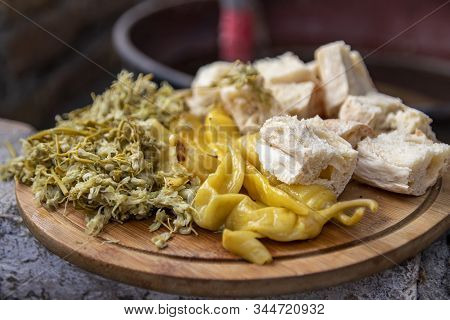 Jonjoli, Pickled Peppers And Slices Of Bread Close-up On A Wooden Board