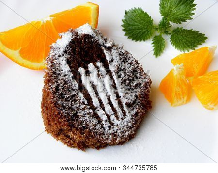Chocolate Muffin With Oranges On A White Background