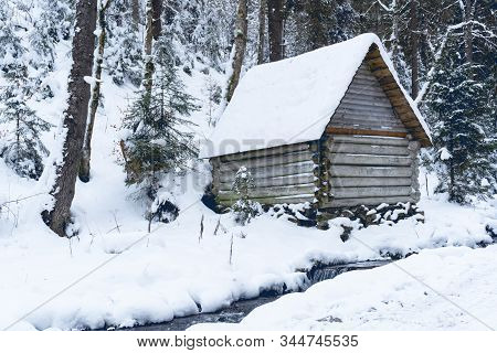 View At Wooden Buiding In Winter Forest, Snow Is All Around. Day Time, Good Background. Winter Fores