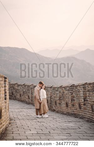 Beautiful Young Couple Showing Affection On The Great Wall Of China