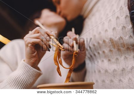 Newlywed Couple Eating Noodles With Chopsticks In Shanghai Outside A Food Market