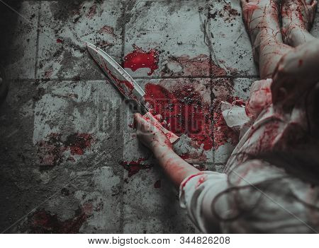 Ghost Zombie Hand Holding Knife With Blood. Hand Full Of Blood And Wrist Cut. Woman Self Harming Wit