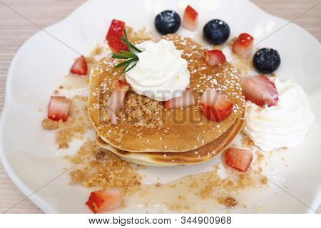 Pancakes Sprinkled With Strawberries And Blueberries.sweet Concept