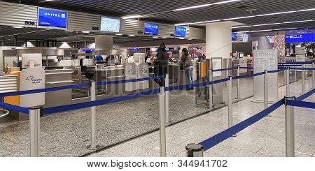 Frankfurt, Germany, 12 26 2019.young Man And Woman Standing In Front Of 2 Different Counters In Fran