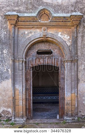 Traditional Door With An Arch. Abandoned Building (kasbah), With A Weathered Wall. Dar Caid , Morocc