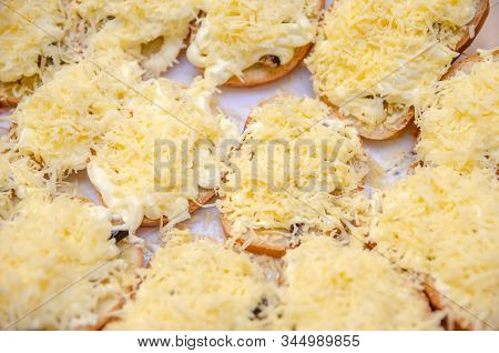 Sandwiches With Sprats, Mayonnaise And Frayed Cheese On A Plate Close-up