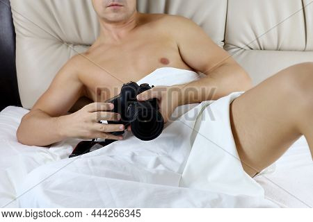 Man With Naked Torso Sitting With Dlsr Camera In The Bed. Concept Of Photography, Erotic Shooting, G