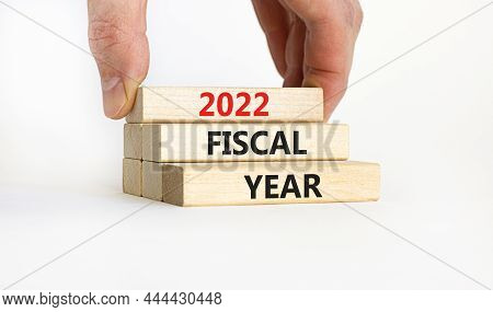 2022 Fiscal New Year Symbol. Concept Words '2022 Fiscal Year' On Wooden Blocks. Businessman Hand. Be