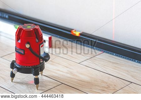 Laser Level And Bubble Levels, Lines On The Wall. Measuring  With Red Laser Level.measurement Accura