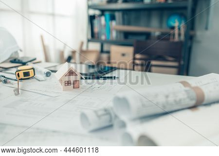 Mini Model House, Pencil, Compass, Tape Measure, Safty Helmet  And Roll Blueprint Plan  On Blueprint