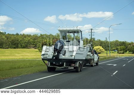 Bruce Highway, Proserpine, Queensland, Australia - December 2021: A Motor Boat On Trailer Towed By S