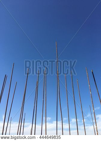 A view of metal bars jutting out from a RCC structure on the construction site. Use of steel bars on a building construction site.