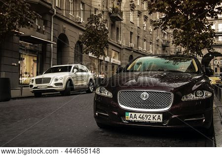 Kiev, Ukraine - June 12, 2021: White English Suv Bentley Bentayga And Jaguar Xj Parked In The City